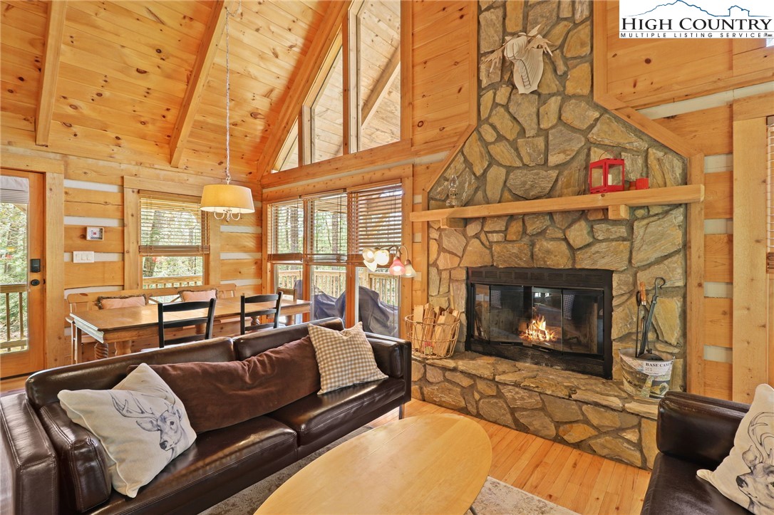 291 Dream Forest Path Banner Elk, NC 28604 - Photo 10 of 43 a living room with furniture a flat screen tv and a fireplace