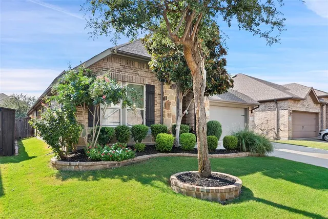a front view of a house with a yard and fountain