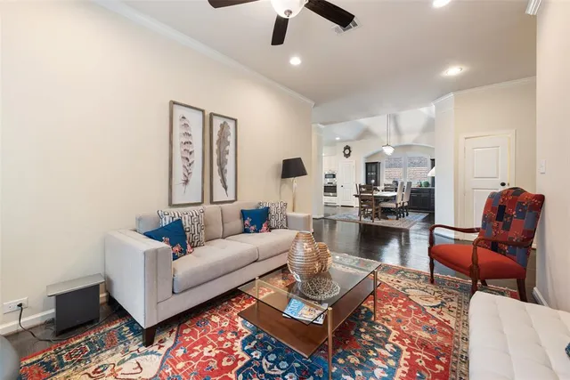 a living room with furniture wooden floor and a chandelier