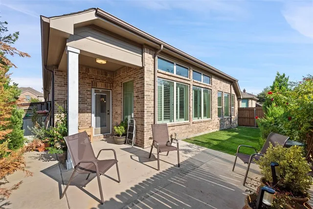 a view of house with backyard and outdoor seating
