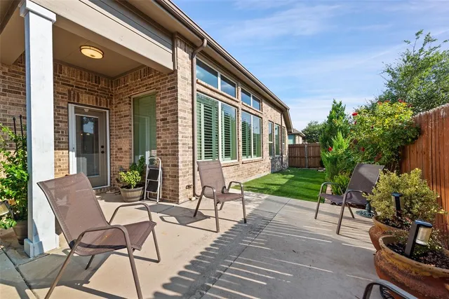 a view of a patio with table and chairs and potted plants
