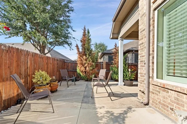 a building outdoor space with patio furniture and potted plants