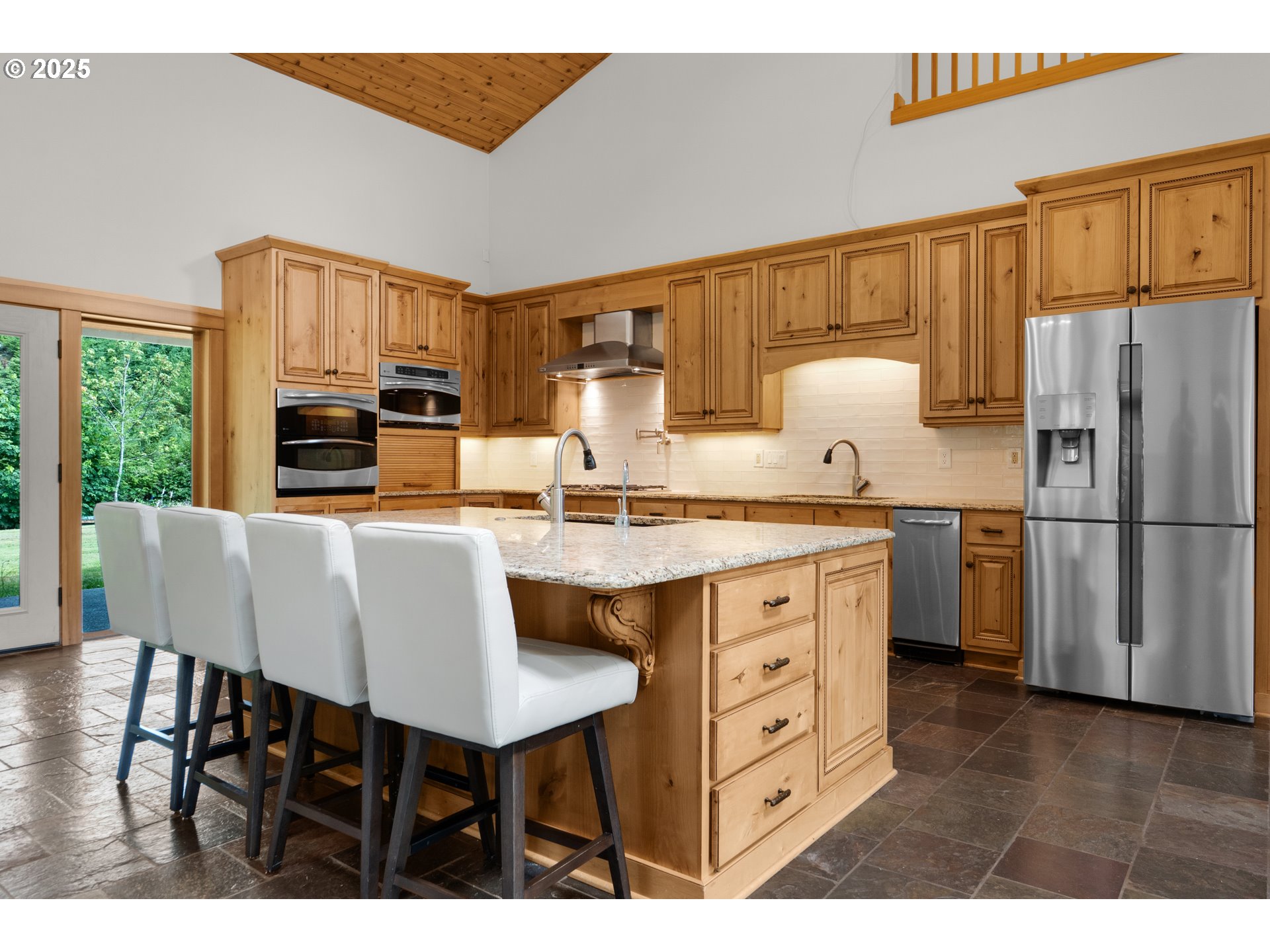 37769 Sunset Highway Seaside, OR 97138 - Photo 14 of 48 a kitchen with a table chairs refrigerator and cabinets