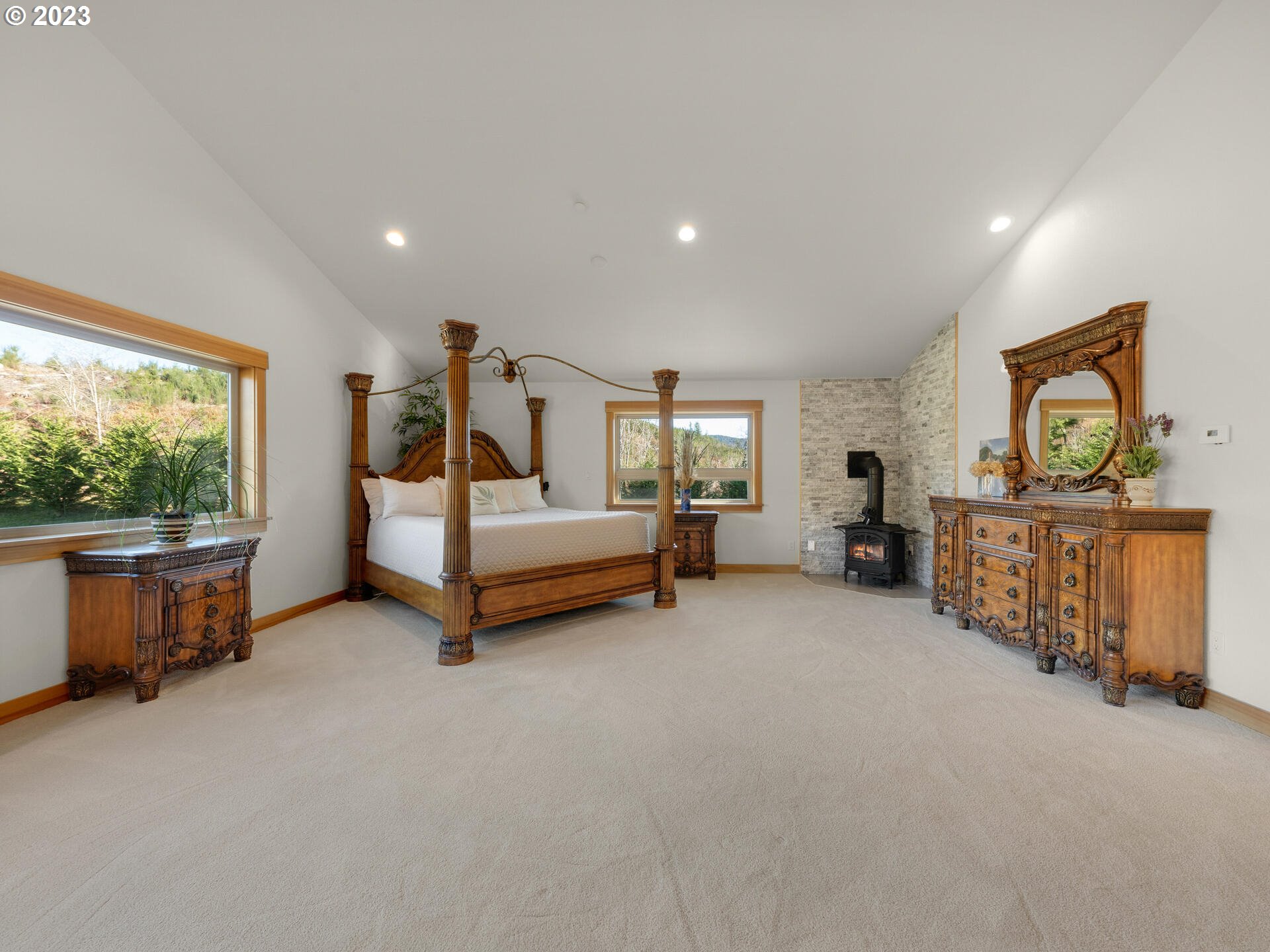 37769 Sunset Highway Seaside, OR 97138 - Photo 15 of 48 a spacious bedroom with a bed and a large window