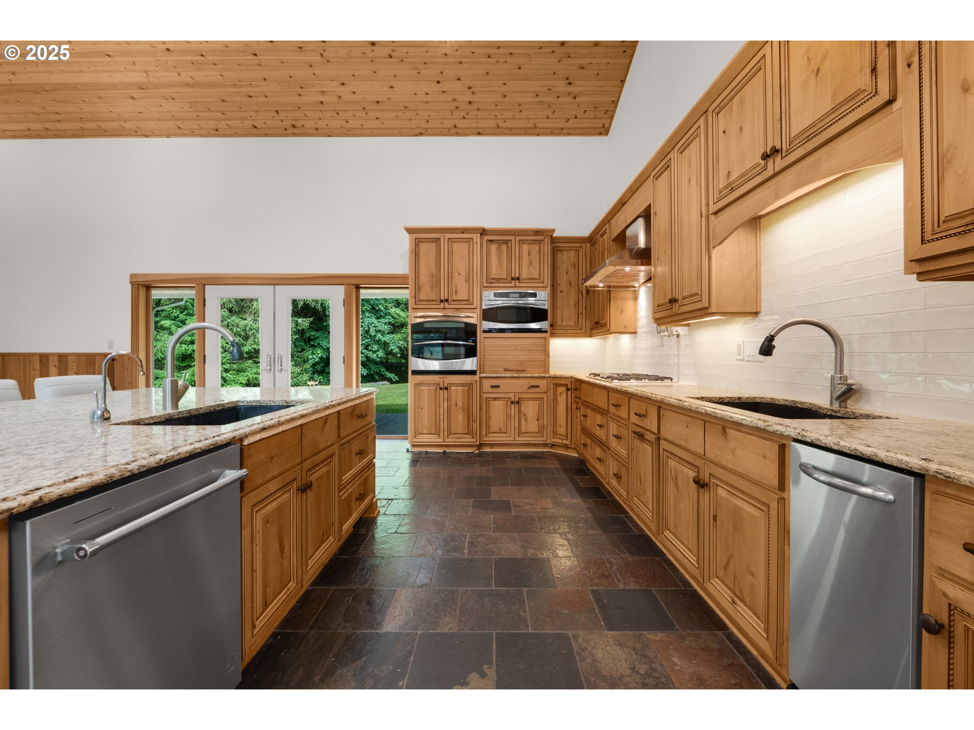 37769 Sunset Highway Seaside, OR 97138 - Photo 28 of 48 a large kitchen with granite countertop a sink and dishwasher a oven with wooden cabinets