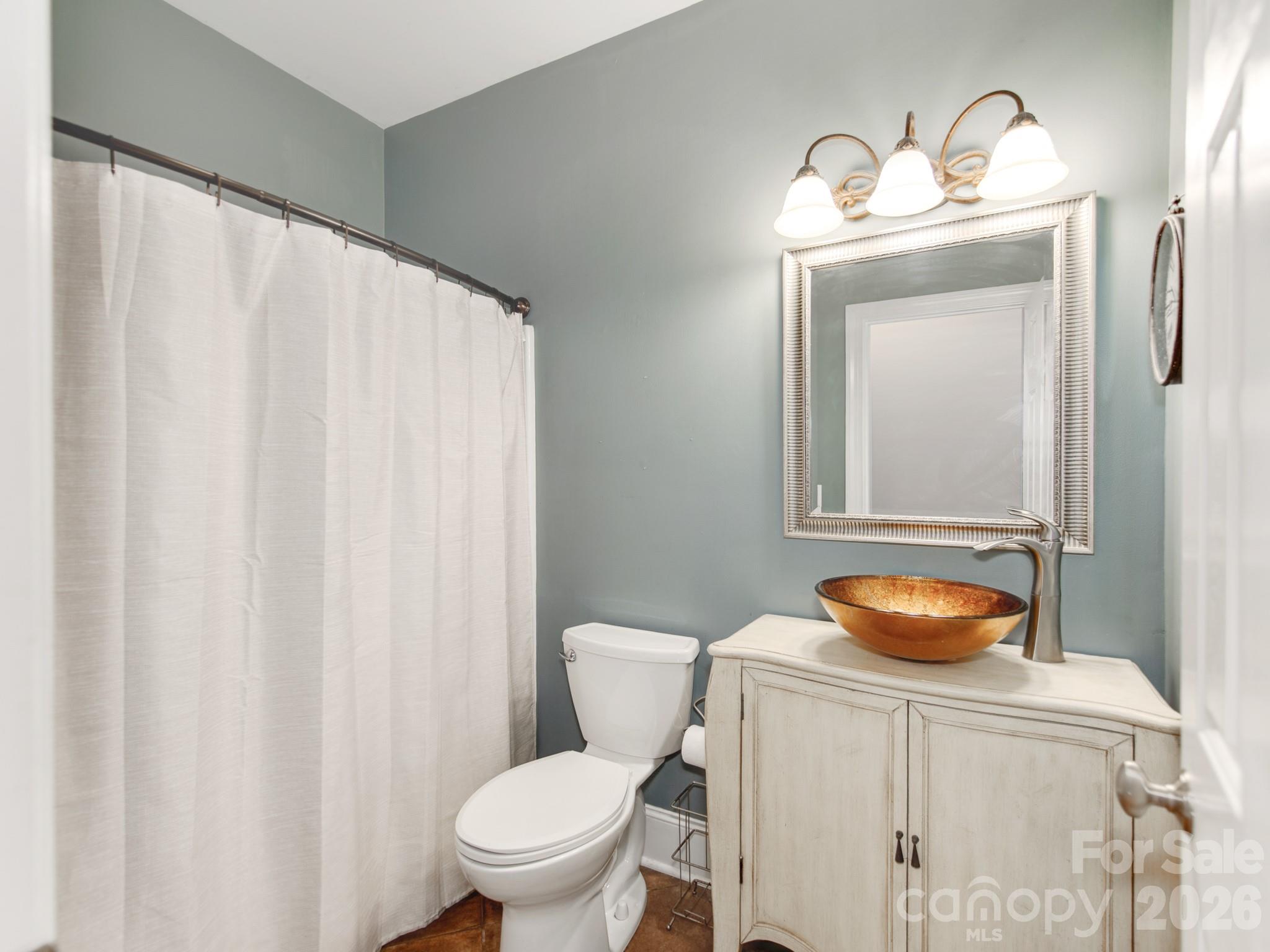 783 Sloan Street Denver, NC 28037 - Photo 27 of 44 a bathroom with a toilet and a sink