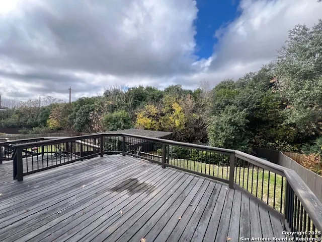 a view of balcony with wooden floor and fence