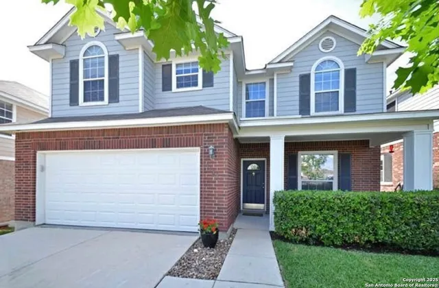 front view of brick house with a yard