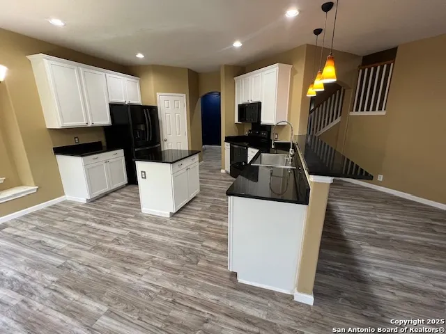 a kitchen with a sink appliances and cabinets