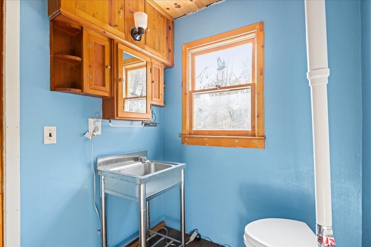 440 Clemmer Ridge Lane West Augusta, VA 24485 - Photo 35 of 39 a bathroom with a toilet sink and mirror