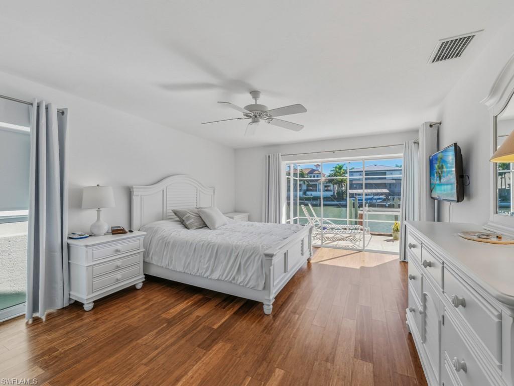396 Conners Avenue Naples, FL 34108 - Photo 16 of 27 a spacious bedroom with a bed and a large window
