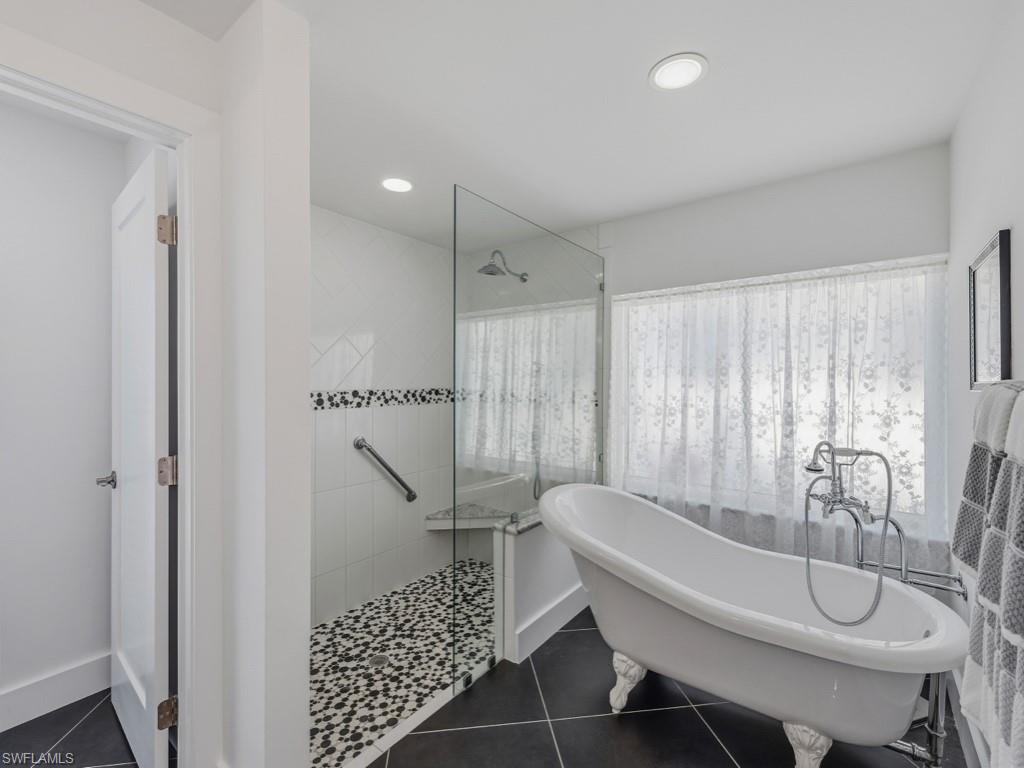 396 Conners Avenue Naples, FL 34108 - Photo 19 of 27 a bathroom with a sink a toilet and shower