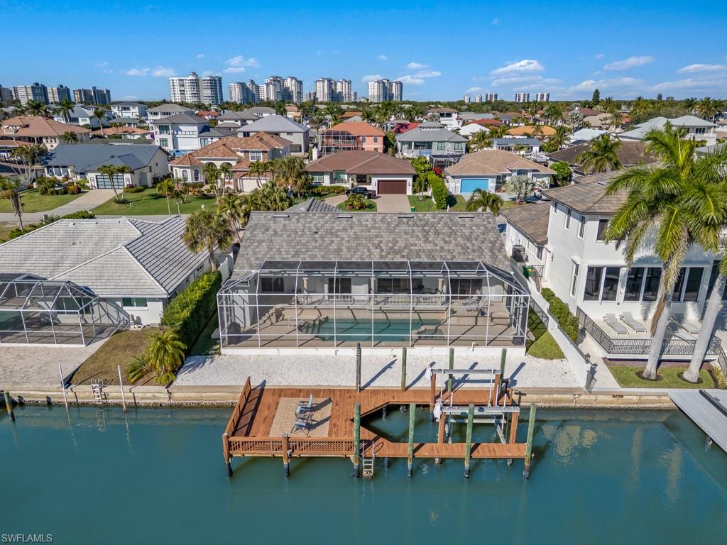 396 Conners Avenue Naples, FL 34108 - Photo 20 of 27 a view of a lake with a city