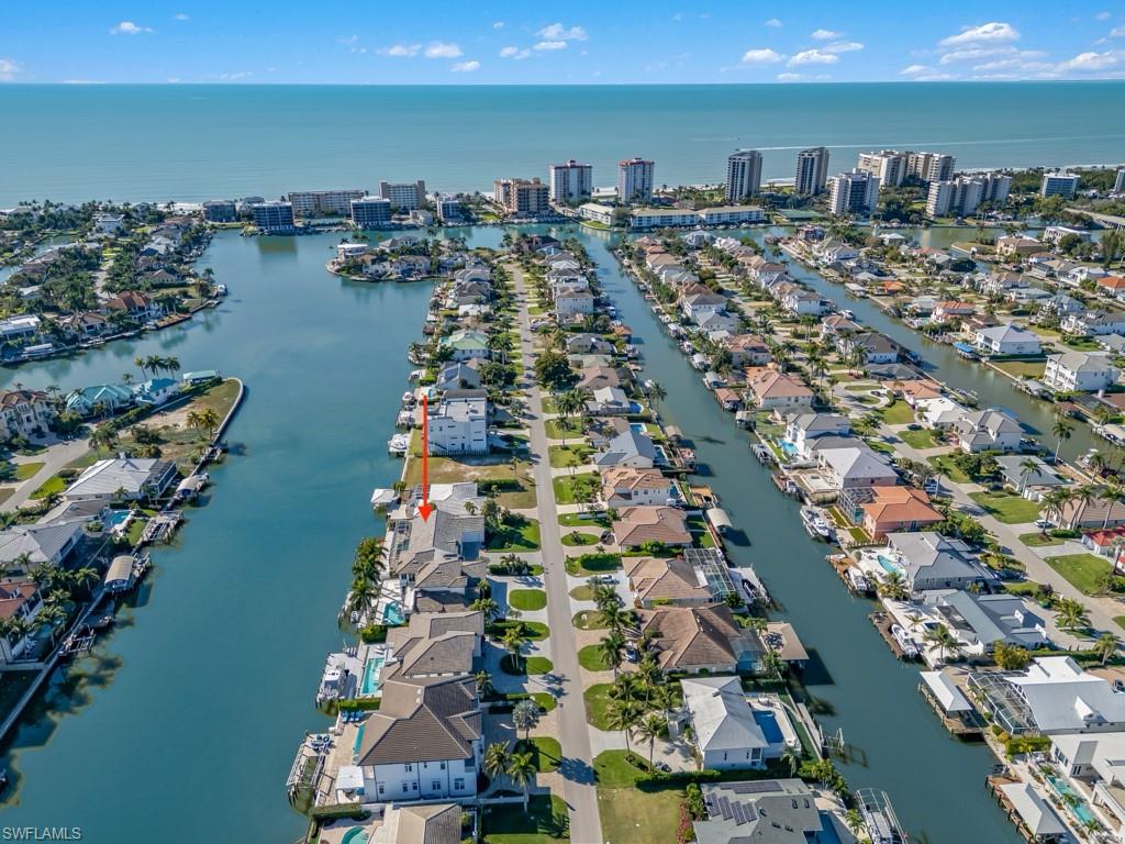 396 Conners Avenue Naples, FL 34108 - Photo 23 of 27 an aerial view of ocean and residential houses with outdoor space