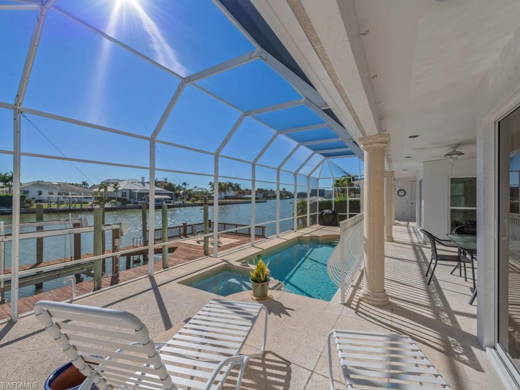 396 Conners Avenue Naples, FL 34108 - Photo 26 of 27 a view of a swimming pool with a patio