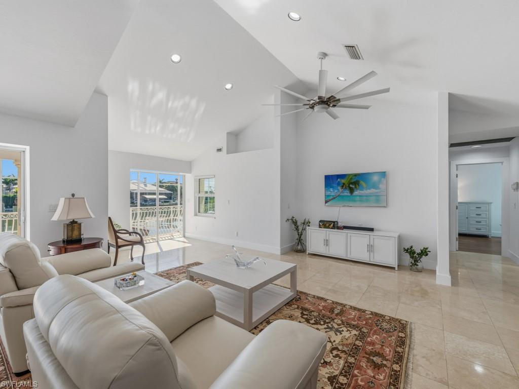 396 Conners Avenue Naples, FL 34108 - Photo 3 of 27 a living room with furniture and a chandelier