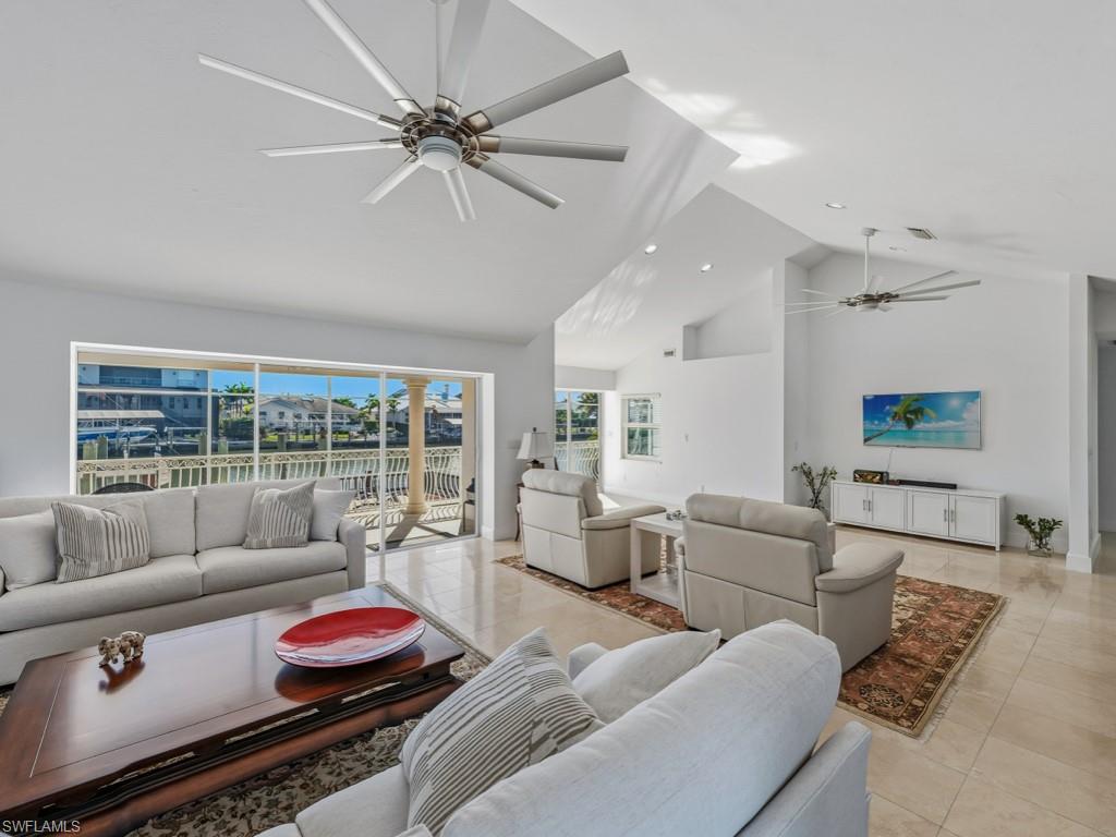 396 Conners Avenue Naples, FL 34108 - Photo 4 of 27 a living room with furniture and a large window