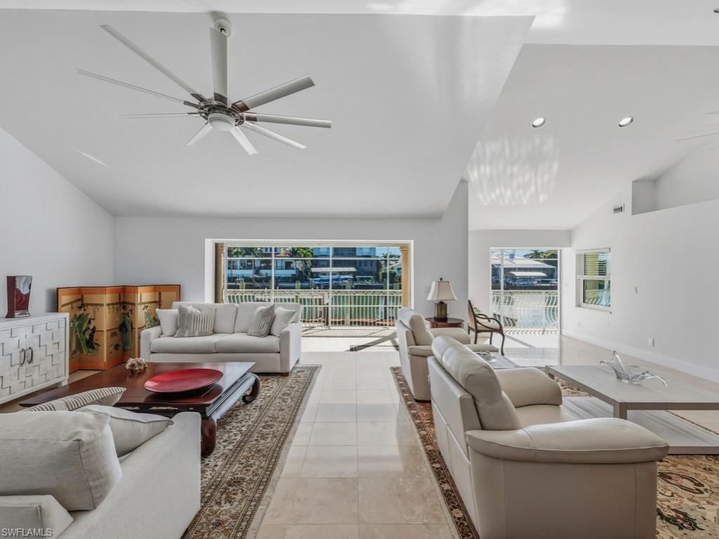 396 Conners Avenue Naples, FL 34108 - Photo 7 of 27 a living room with furniture and a large window
