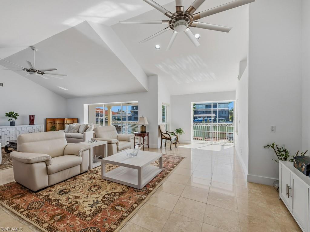 396 Conners Avenue Naples, FL 34108 - Photo 8 of 27 a living room with furniture and wooden floor