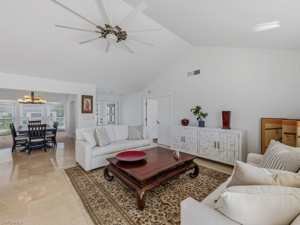 396 Conners Avenue Naples, FL 34108 - Photo 10 of 27 a living room with furniture and a rug
