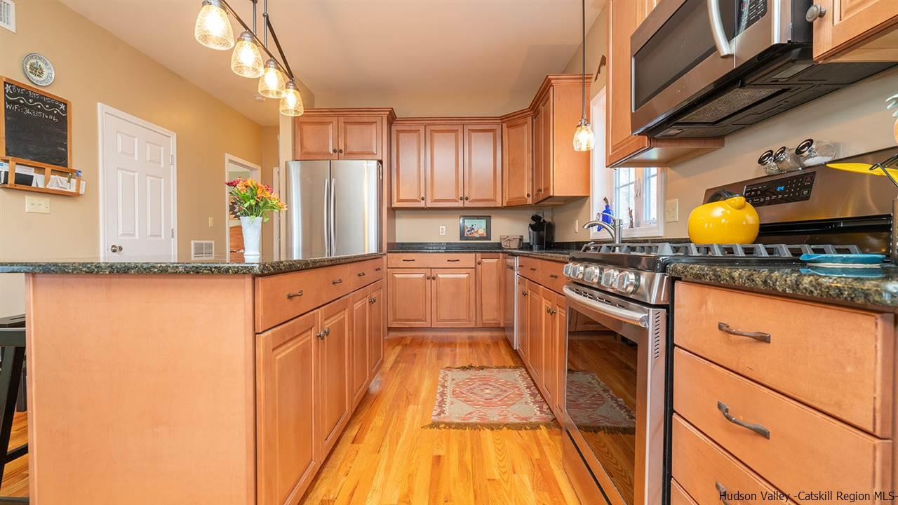 2108 Bruynswick Road Wallkill, NY 12589 - Photo 11 of 34 a kitchen with stainless steel appliances granite countertop a sink stove and cabinets