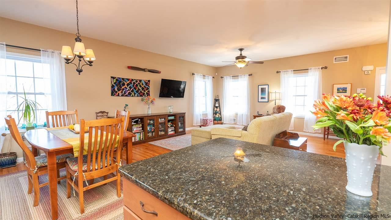 2108 Bruynswick Road Wallkill, NY 12589 - Photo 13 of 34 a living room with furniture a chandelier and a dining room