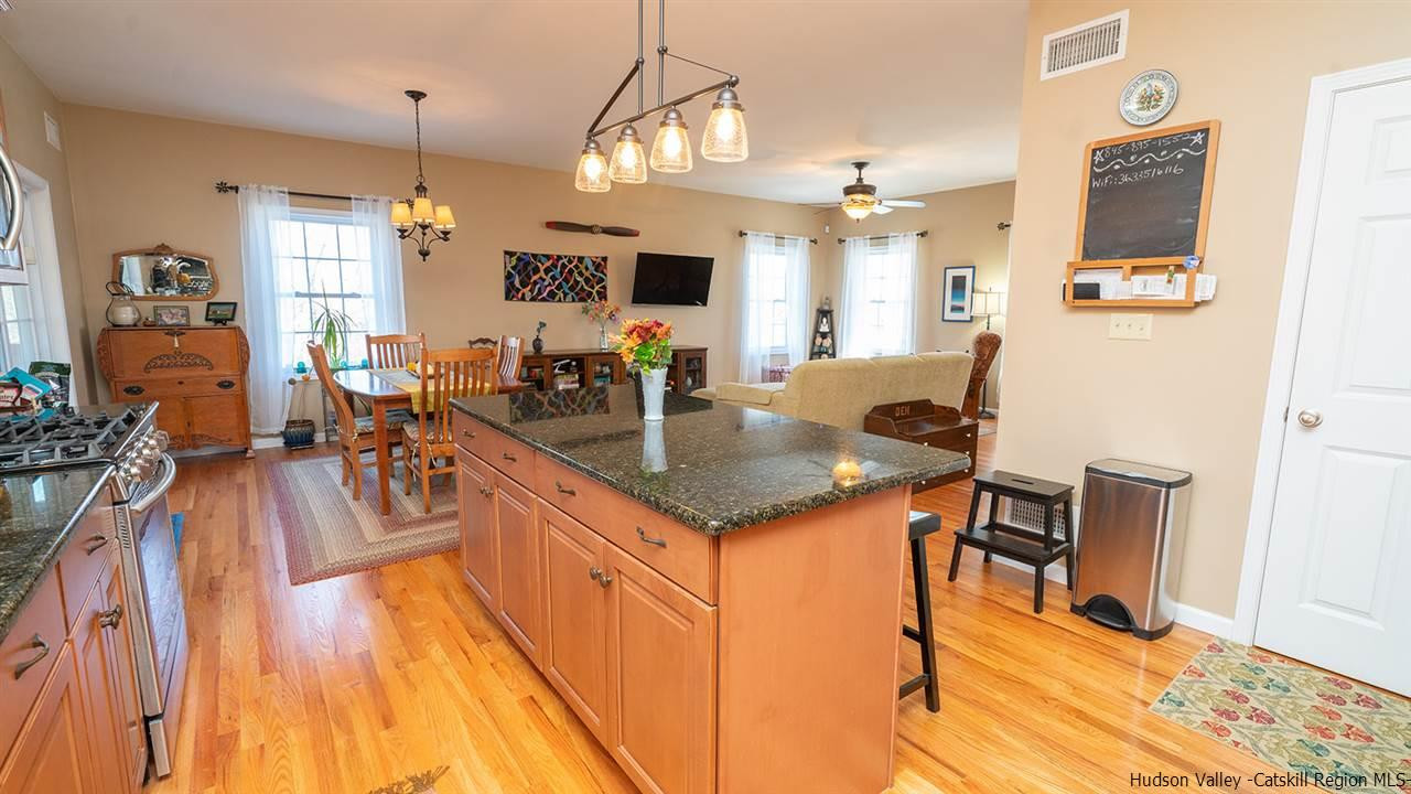 2108 Bruynswick Road Wallkill, NY 12589 - Photo 14 of 34 a kitchen with granite countertop a sink stove and wooden floor