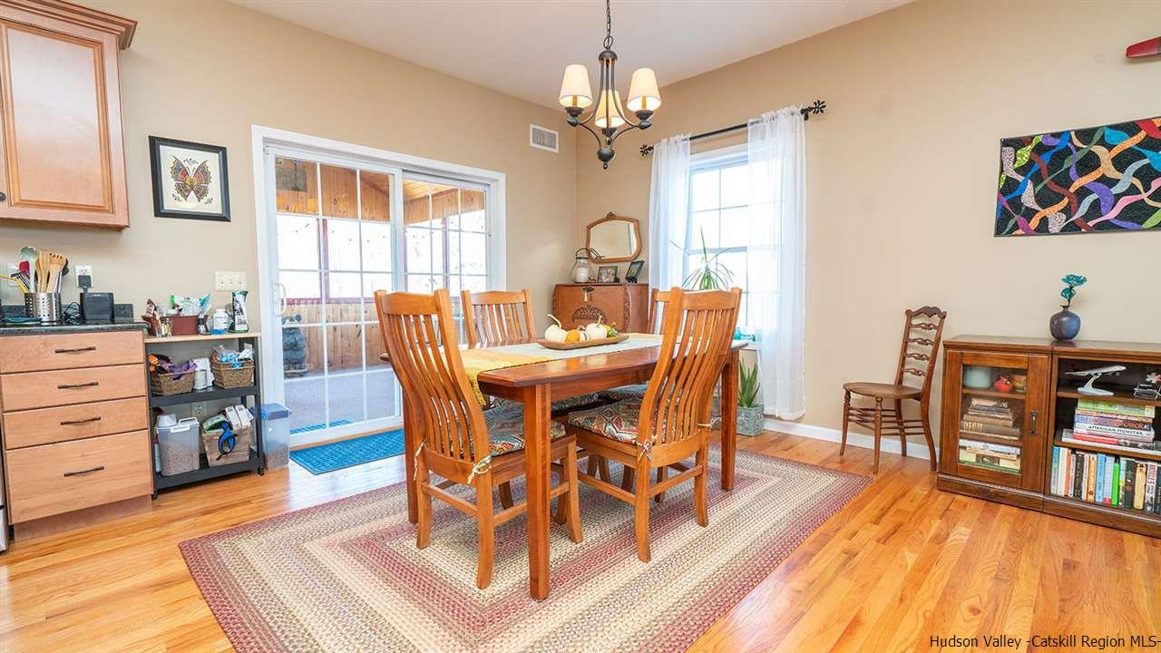 2108 Bruynswick Road Wallkill, NY 12589 - Photo 16 of 34 a dining room with furniture and wooden floor