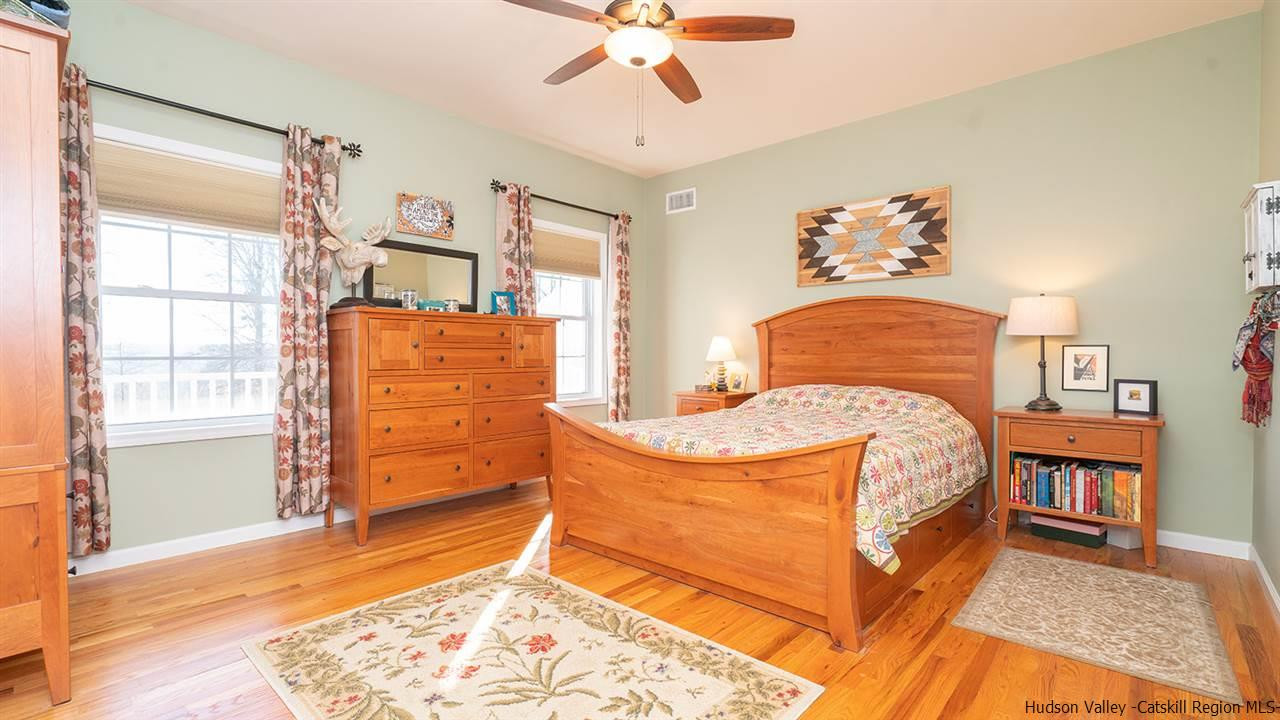 2108 Bruynswick Road Wallkill, NY 12589 - Photo 17 of 34 a bedroom with a bed and wooden floor
