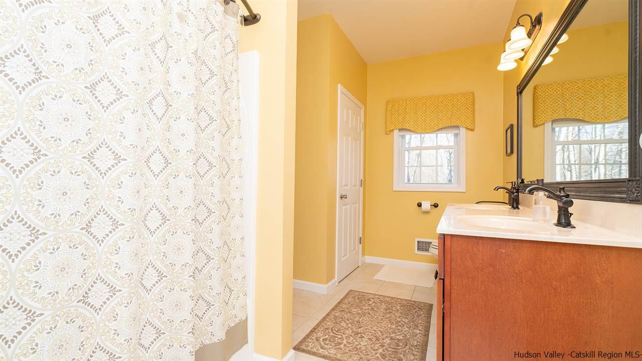 2108 Bruynswick Road Wallkill, NY 12589 - Photo 18 of 34 a bathroom with a sink a mirror and a shower