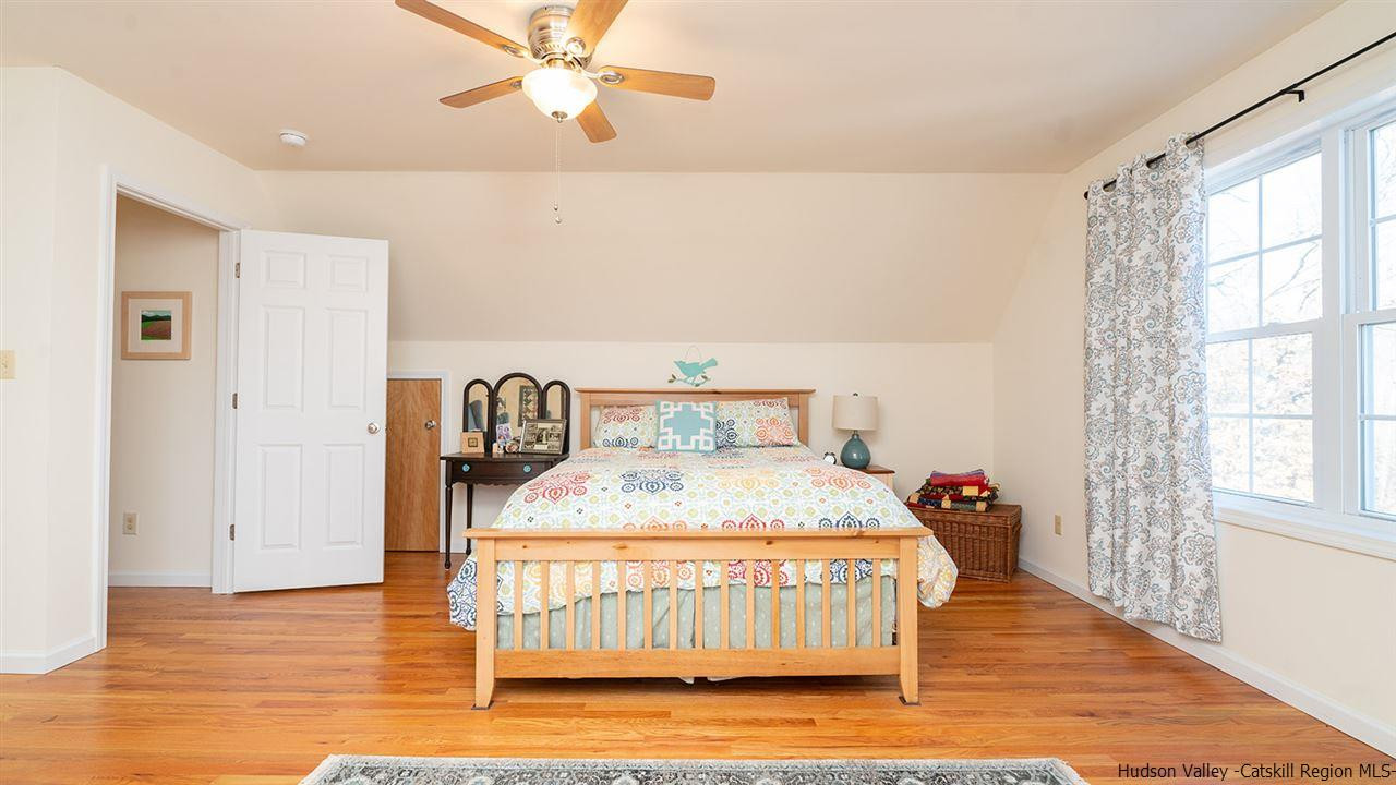 2108 Bruynswick Road Wallkill, NY 12589 - Photo 20 of 34 a bedroom with a bed and wooden floor