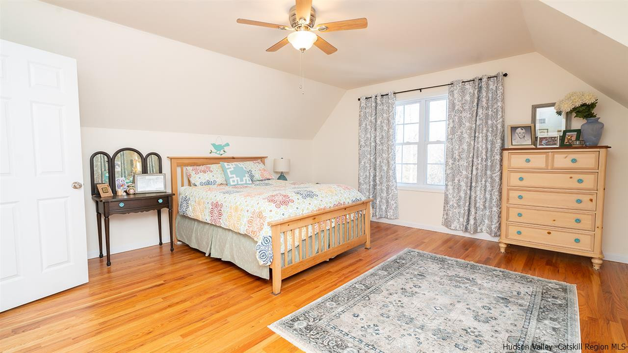 2108 Bruynswick Road Wallkill, NY 12589 - Photo 21 of 34 a bedroom with a bed and wooden floor