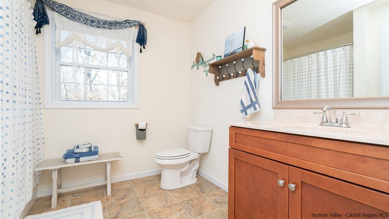 2108 Bruynswick Road Wallkill, NY 12589 - Photo 23 of 34 a bathroom with a sink toilet and window