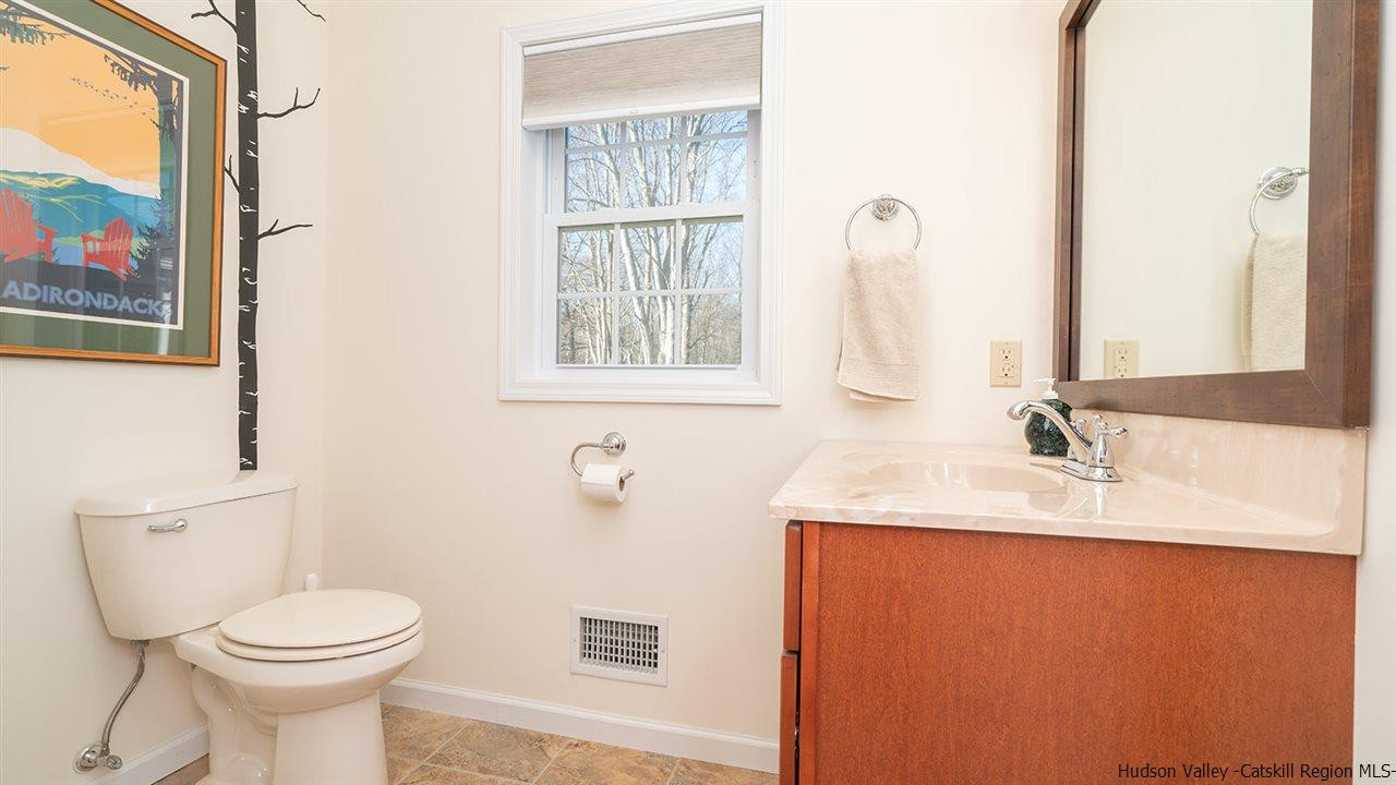 2108 Bruynswick Road Wallkill, NY 12589 - Photo 25 of 34 a bathroom with a sink a toilet and mirror