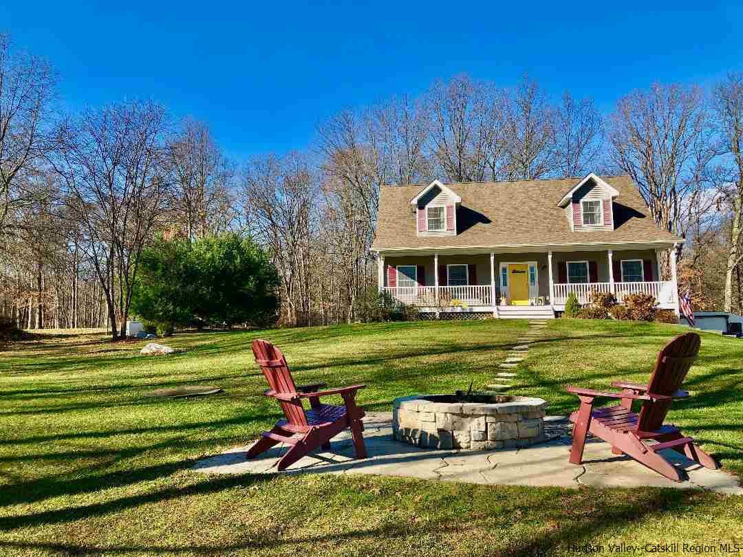 2108 Bruynswick Road Wallkill, NY 12589 - Photo 5 of 34 a front view of a house with a yard table and chairs