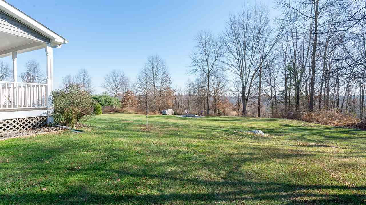 2108 Bruynswick Road Wallkill, NY 12589 - Photo 6 of 34 a backyard of a house with a yard and outdoor seating