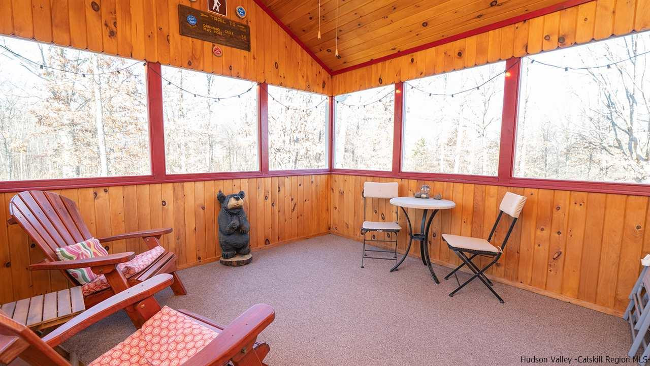 2108 Bruynswick Road Wallkill, NY 12589 - Photo 8 of 34 an outdoor sitting area with couch and wooden fence