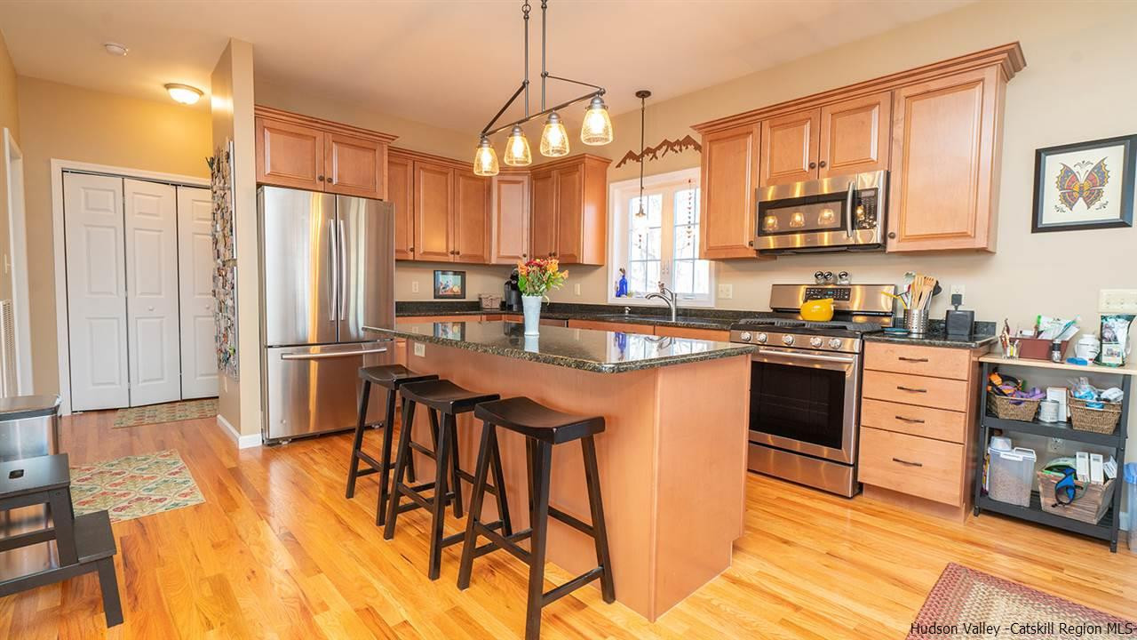 2108 Bruynswick Road Wallkill, NY 12589 - Photo 10 of 34 a kitchen with stainless steel appliances granite countertop a stove a sink dishwasher and a refrigerator with wooden floor