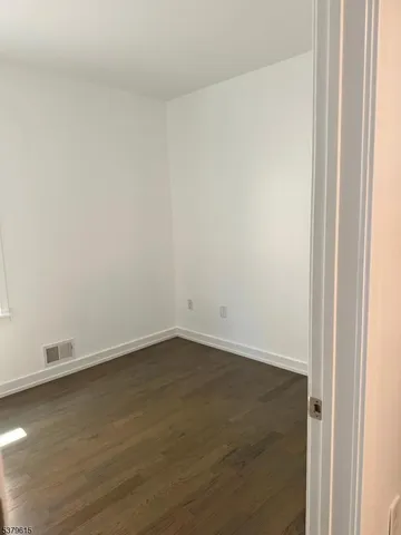 an empty room with wooden floor