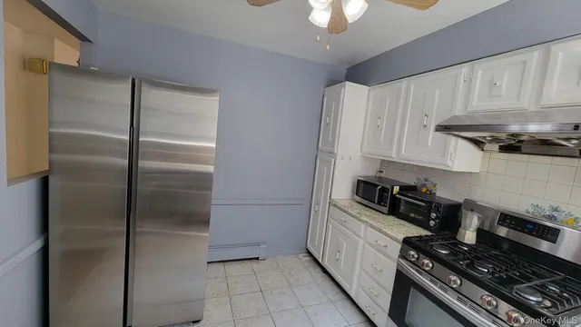 a kitchen with stainless steel appliances a refrigerator a stove a sink and dishwasher