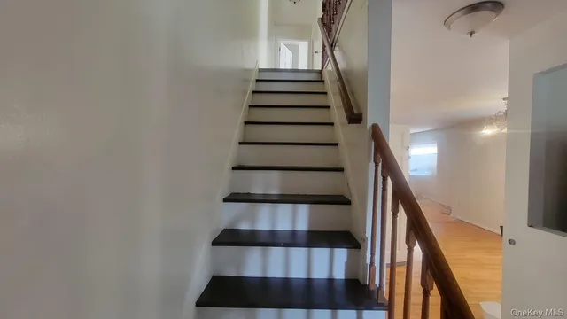a view of entryway and gallery with wooden floor