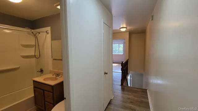 a bathroom with a shower and a sink