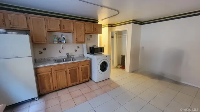a kitchen with a refrigerator and cabinets