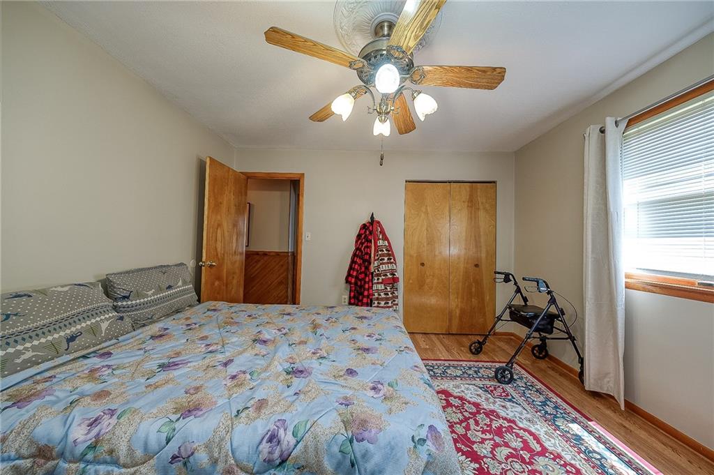 704 Unionville Road Prospect, PA 16052 - Photo 11 of 25 a bedroom with a bed and wooden floor