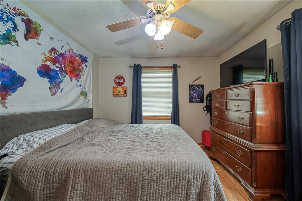 704 Unionville Road Prospect, PA 16052 - Photo 13 of 25 a bedroom with a bed and a flat screen tv