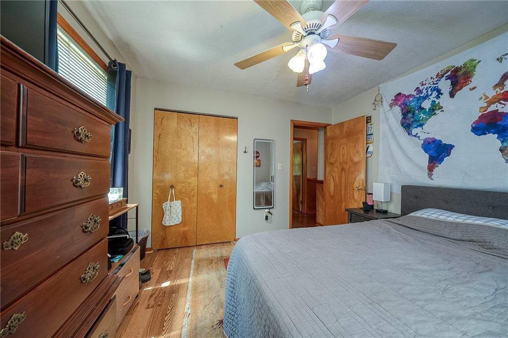 704 Unionville Road Prospect, PA 16052 - Photo 14 of 25 a bedroom with a bed and a chandelier