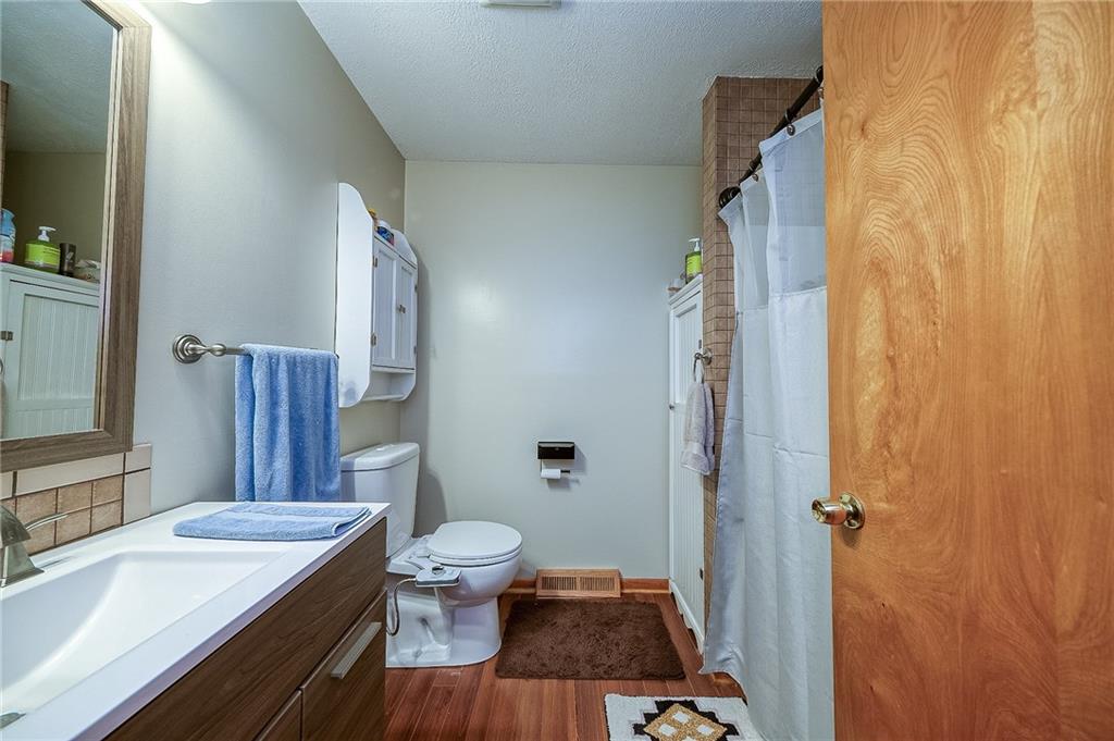 704 Unionville Road Prospect, PA 16052 - Photo 16 of 25 a bathroom with a sink a toilet a mirror and shower