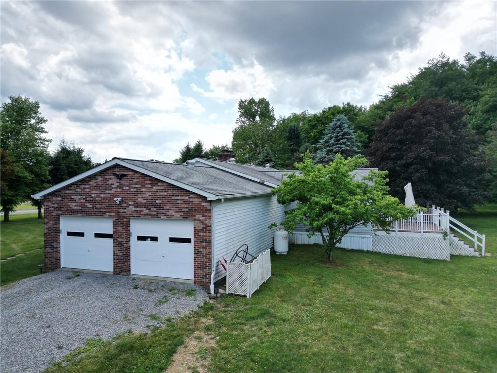 704 Unionville Road Prospect, PA 16052 - Photo 18 of 25 a front view of a house with a garden