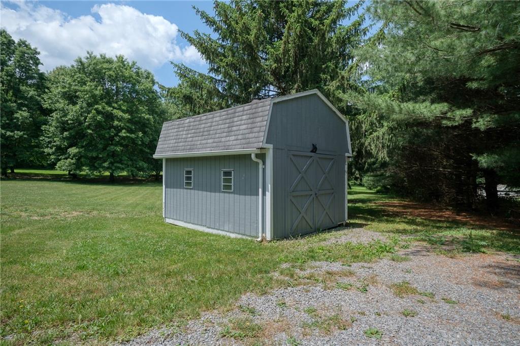 704 Unionville Road Prospect, PA 16052 - Photo 20 of 25 a view of a tiny house with a yard and large tree