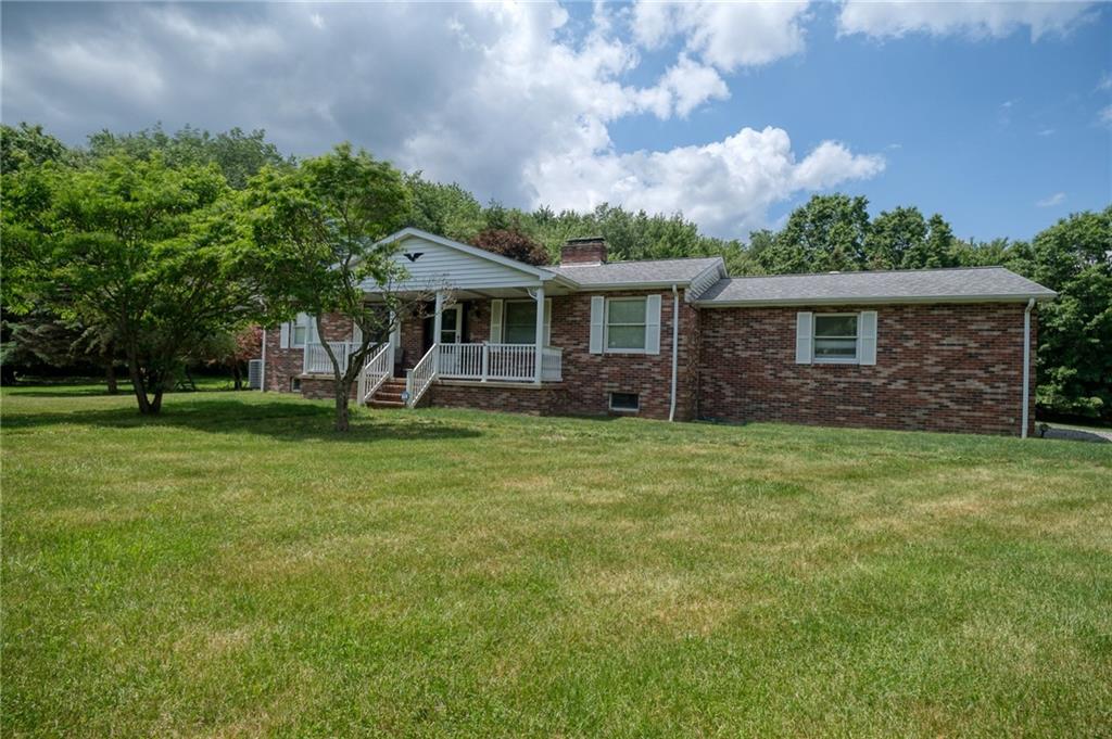 704 Unionville Road Prospect, PA 16052 - Photo 2 of 25 a front view of a house with garden